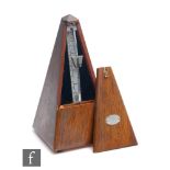A Maelzel metronome in mahogany case, height 23cm.