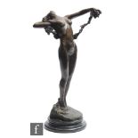A late 20th Century Art Deco style bronze figure of a maiden leaning back holding a vine and a bunch