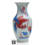 A Chinese late Qing Dynasty (1644-1912) blue and white baluster vase, decorated with iron-red and