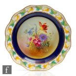 A Royal Doulton cabinet plate decorated by Percy with a hand painted floral spray within a blue