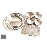 Five items of hallmarked silver to include four napkin rings and a small circular bon bon dish, with