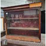 A small 19th Century mahogany chemist wall display cabinet enclosed by a single glazed door, the