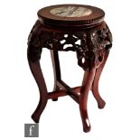 A Chinese rosewood jardinière stand, the four swept supports with lotus flower carving and inset