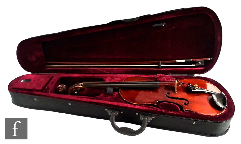 A late 19th Century German violin, length 36cm, and a bow, in later black zip case.