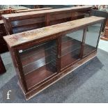 An Edwardian mahogany display cabinet, the top and bottom sections each enclosed by three glazed
