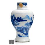 A Chinese Kangxi period (1662-1722) blue and white baluster vase, the splayed foot extending to a