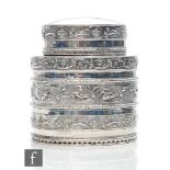 A hallmarked silver oval tea caddy with banded embossed foliate scroll decoration to body and pull