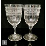 A pair of 19th Century clear crystal goblets, the ovoid bowl finely engraved with a monogrammed