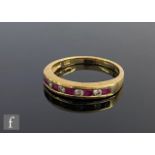 An 18ct hallmarked ruby and diamond half eternity ring comprising nine alternating channel set