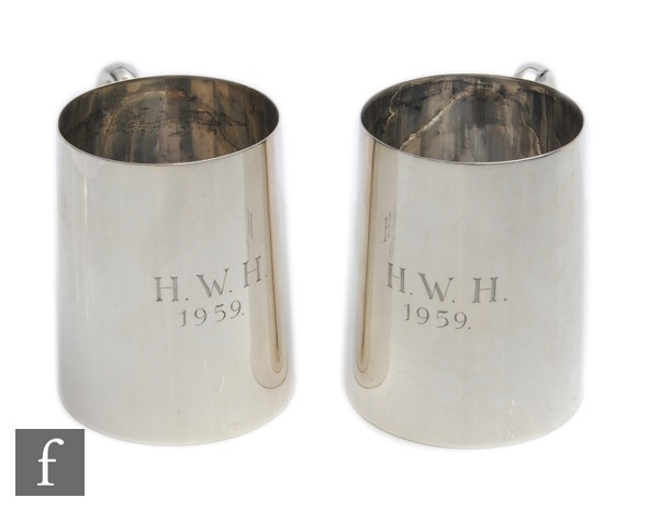 A pair of hallmarked silver half pint tankards of plain form, total weight 11.7oz, heights 9cm,