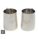 A pair of hallmarked silver half pint tankards of plain form, total weight 11.7oz, heights 9cm,