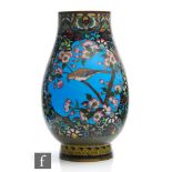 A Japanese Meiji Period (1868-1912) vase, of rounded form rising from a high footring,