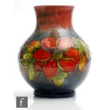 A large Moorcroft vase of footed ovoid form with a flared collar neck decorated in the Flambe