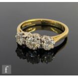 An 18ct hallmarked diamond three stone ring, brilliant cut, claw set stones, total weight