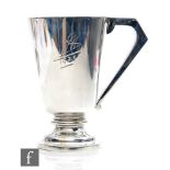 A hallmarked silver pint pedestal tankard of plain conical shape, terminating in angular handle,