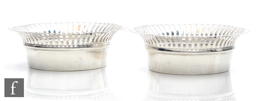 A pair of hallmarked silver circular bon bon dishes each with pierced flaring boarders, weight