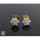 A pair of 18ct white gold diamond cluster stud earrings each comprising seven brilliant cut claw set