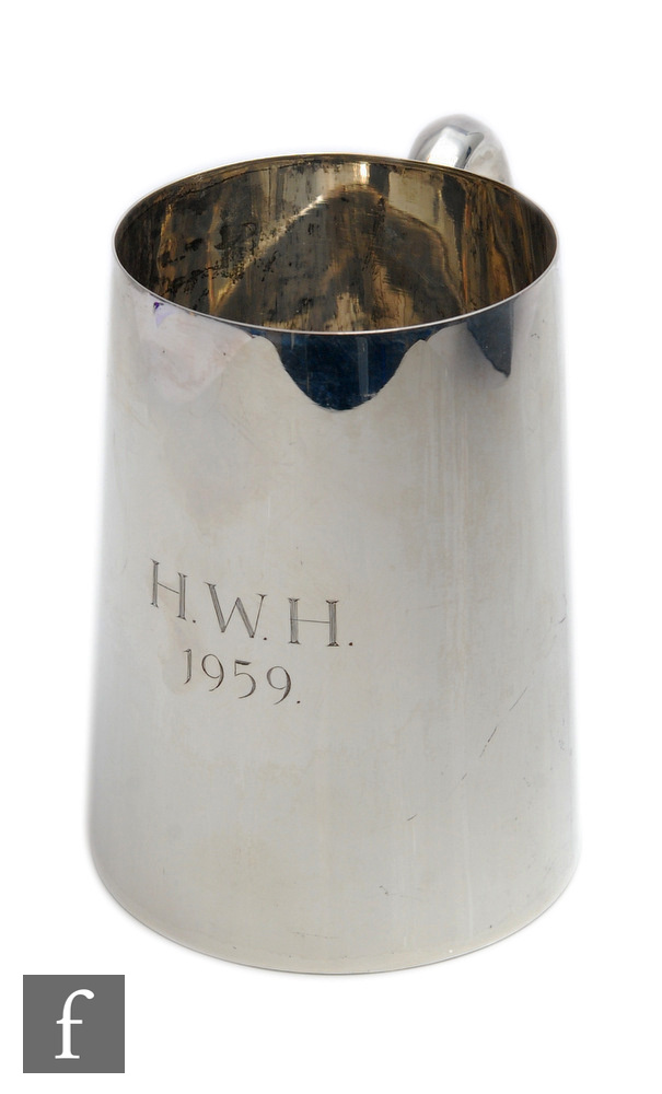 A hallmarked silver pint tankard of plain form terminating in C scroll handle, weight 11oz, height