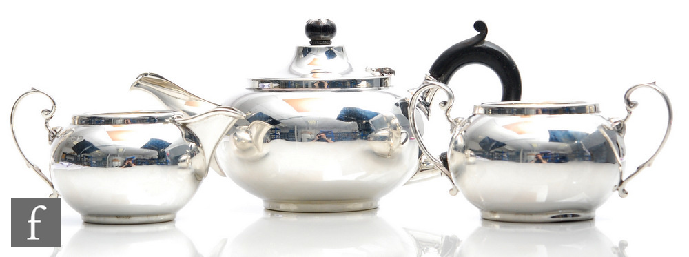 A hallmarked silver three piece bachelor's tea set of plain bulbous form, total weight 15oz,