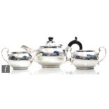 A hallmarked silver three piece bachelor's tea set of plain bulbous form, total weight 15oz,