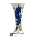 A boxed Moorcroft Pottery trumpet form vase decorated in the Delphinium pattern designed by Kerry