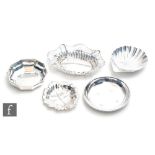 Four hallmarked silver assorted small bon bon dishes to include leaf and shell shaped examples,