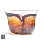 A 20th Century glass bowl of compressed ovoid form with flared rim, with mottled and streaked