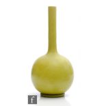 An early 20th Century Burmantofts solifleur or bottle vase glazed in lime green, impressed mark,