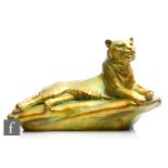 A large Zsolnay eosin glaze model of a tiger reclining on a rock, inscribed Tigus regalis to the