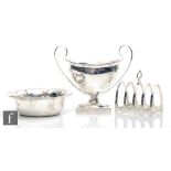 Three items of hallmarked silver a small twin handled pedestal bowl, a small circular bowl and a