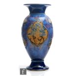 A late 19th Century Royal Doulton vase decorated with tubelined roundels with cornflowers against