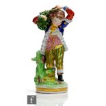 A 19th Century Derby figurine modelled as a boy dressed in gilt trousers, patterned waistcoat and an