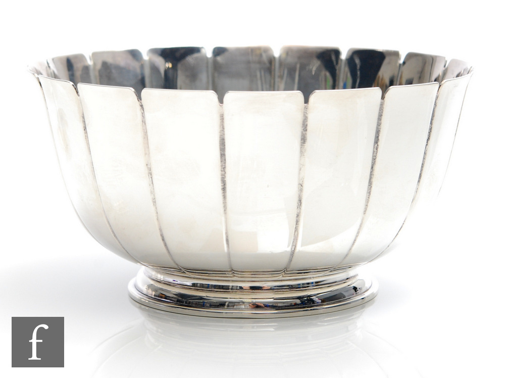 A hallmarked silver circular pedestal bowl comprising eighteen plain flaring panels to a stepped
