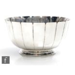 A hallmarked silver circular pedestal bowl comprising eighteen plain flaring panels to a stepped