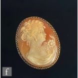 A modern 18ct mounted oval cameo brooch, head and shoulder profile of a woman, all to a pierced