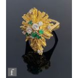 A 1970s 18ct emerald and diamond cluster ring, thirteen individually claw set stones, five