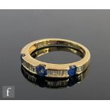A 14ct sapphire and diamond half eternity ring, three sapphires spaced by baguette channel set