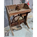 A 19th Century pine pharmaceutical root crusher, with tray back and iron chute over an iron five