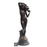 A late 20th Century bronze figure of a naked maiden holding an urn near a Doric column, circular