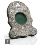 An Edwardian hallmarked silver easel photograph frame with central circular window within a