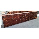 A large 19th Century bank of fifty chemist's drawers fitted with two rows of different size