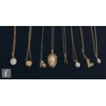 Eight assorted 9ct pendants and chains to include a cameo, a garnet and a cultured pearl example,