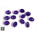 Twelve cut and polished loose unused amethyst stones, oval facet cut, length 10mm x 8mm x 5mm,