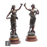 A late 19th to early 20th Century near pair of French patinated spelter figures, modelled as a