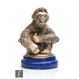 A Basil Matthews model of a seated chimpanzee eating a banana, titled Jenny, painted marks and