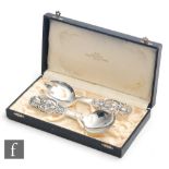 A cased pair Danish silver serving spoons each with pierced foliate decoration to terminals total