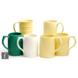 Six 1930s Art Deco Wedgwood Keith Murray mugs comprising one in matt straw with raised bands to