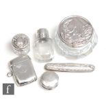 Six early 20th Century items of hallmarked silver three small dressing table jars, a vesta case, a