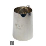 A hallmarked silver pint tankard of plain form terminating in C scroll handle, weight 11oz, height