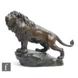 A late 19th to early 20th Century French bronze study, modelled as a stylised lion standing on a